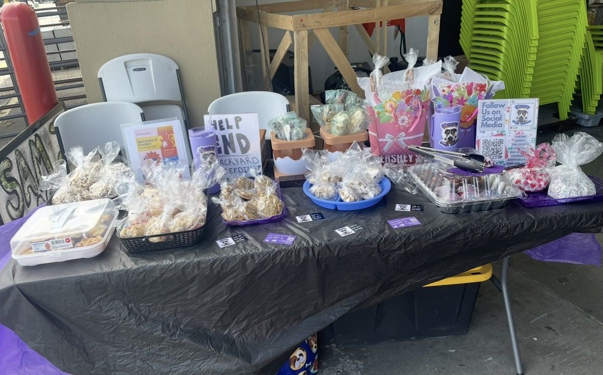Full S’more Dogs bake sale table with treats and QR code signs