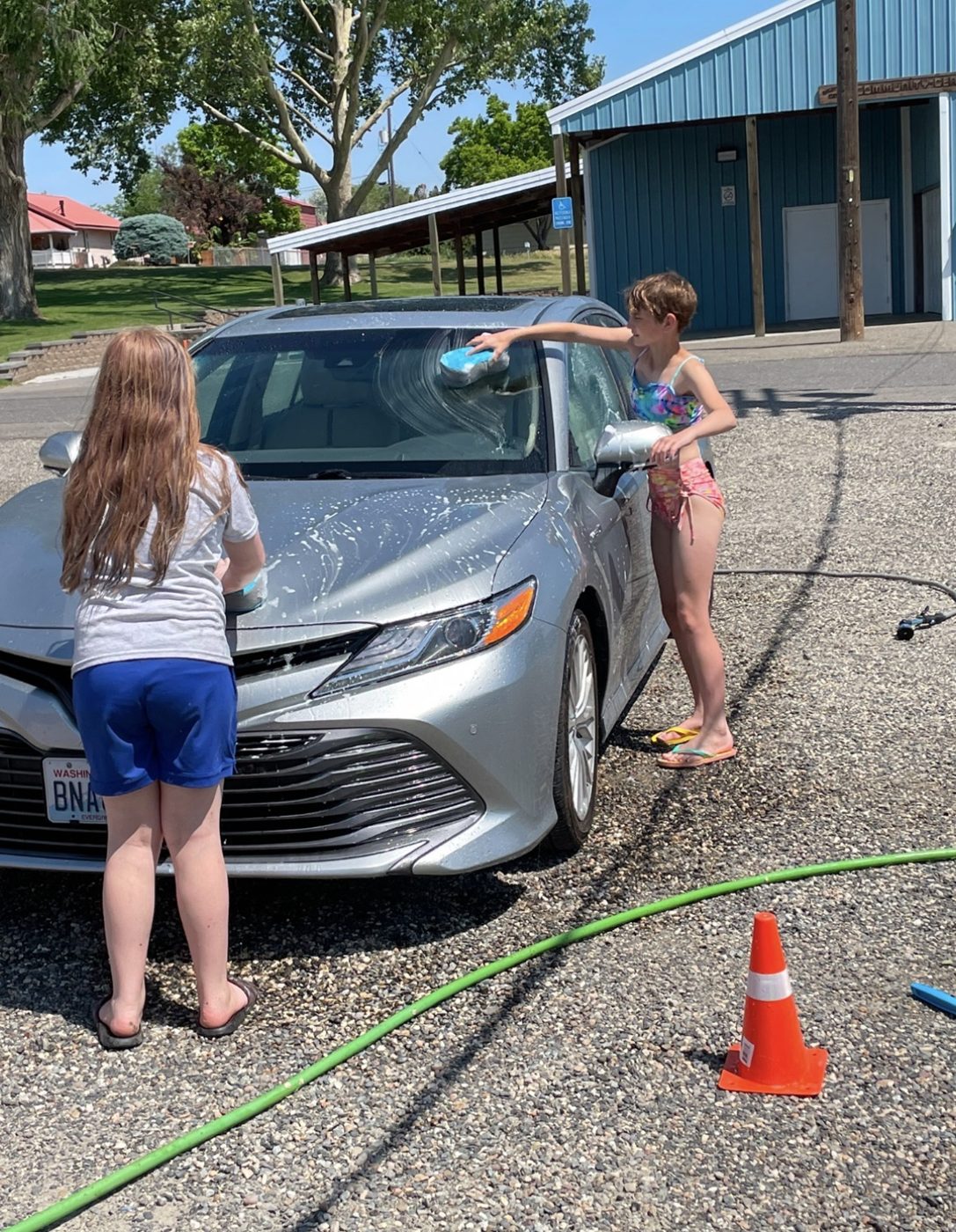 Kids washing a car at a S’more Dogs Rescue car wash